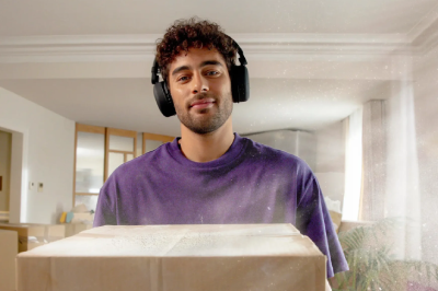 man in purple jumper with cat in his arms
